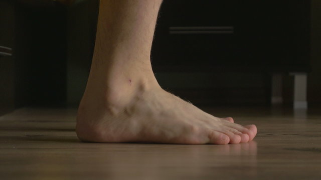 4k UHD - Young male feet getting out of bed