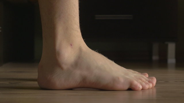 4k UHD - Young male feet getting out of bed