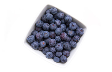 Blueberries on square bowl on a white background seen from above