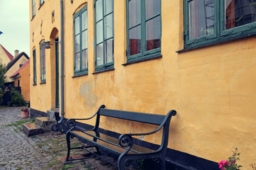 Yellow house and bench