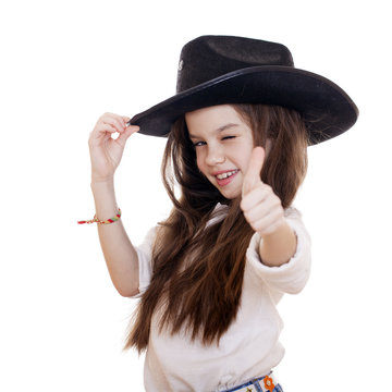 Portrait of a beautiful little girl in a black cowboy hat