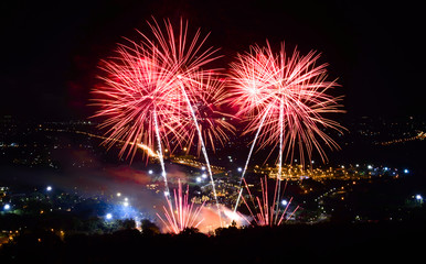 Fototapeta na wymiar Fireworks on night city background
