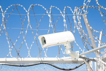 Camcorder and barbed wire on fence closeup