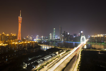 Fototapeta na wymiar traffic blur motion on bridge with night cityscape background