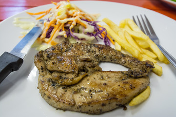Pork chop on orange table