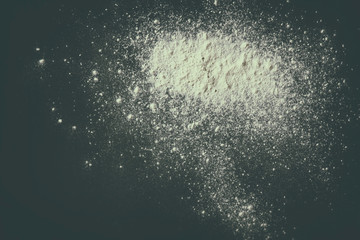 white podwer blast over black textured background  