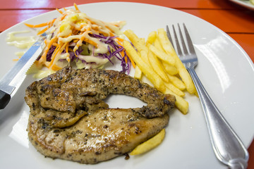 Pork chop on orange table