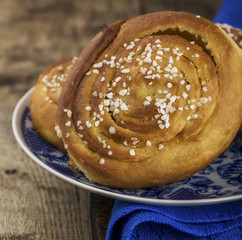 Fresh sugar buns on a blue plate with