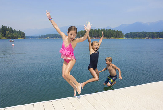 Kids Playing At The Lake On Their Summer Vacation