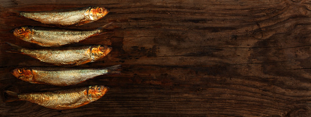 herring sprats smoked wooden table background