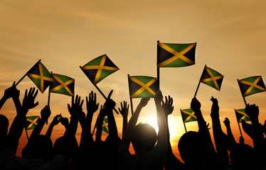 Group of People Waving Flag Jamaica Back Lit Concept