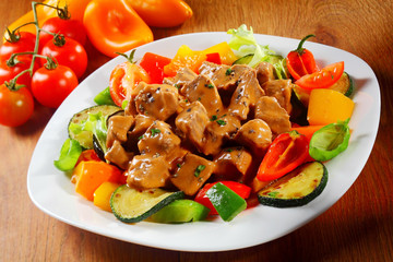 Gourmet Saucy Cooked Meat or goulash with Spices on a Plate