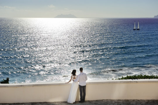bride and groom near sea in wedding day