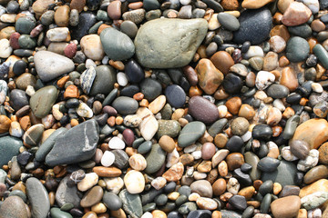 Texture of variety of pebbles on beach