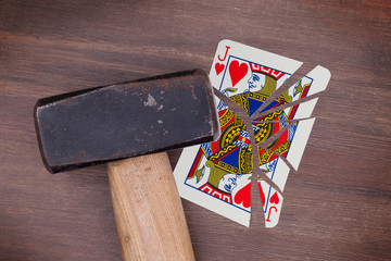 Hammer with a broken card, jack of hearts