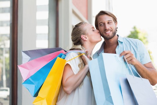 Attractive couple holding shopping bags