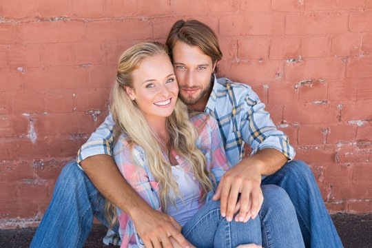 Attractive Couple Sitting On Ground