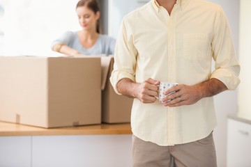 Young couple unpacking boxes in kitchen