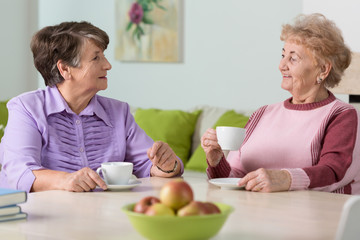 Obraz na płótnie Canvas Elderly women drinking coffee