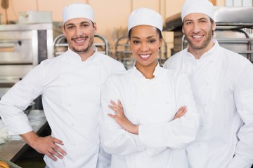 Team of bakers smiling at camera