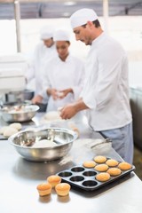 Team of bakers working at counter