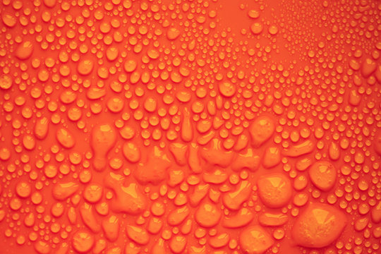 Water drops. Orange background. (soft focus, toned photo).