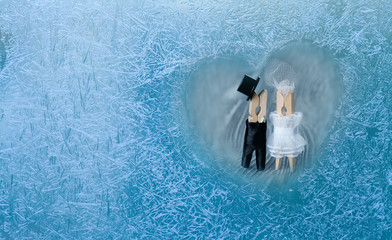Romantic couple. Man, woman in frozen heart.