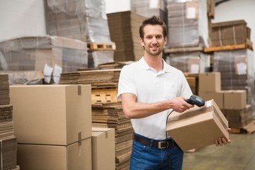 Worker scanning package in warehouse