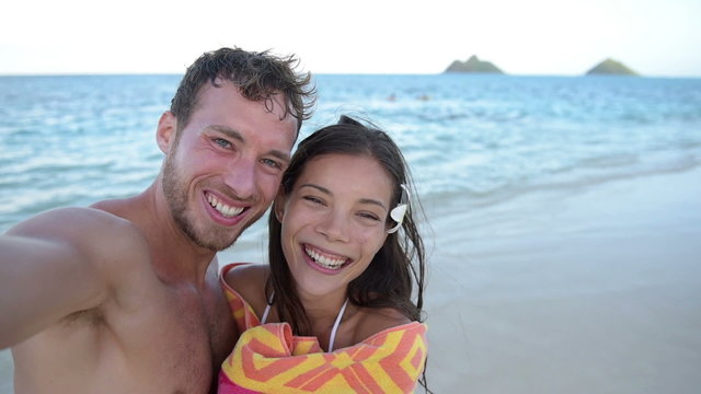 Selfie - beach couple taking self portrait video 