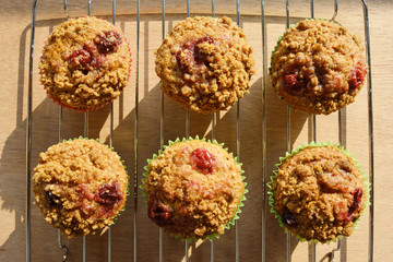 Banana crumble with mix berries on top on a cooling rack