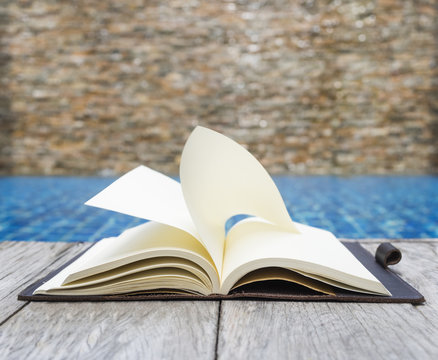 Open Book with Flip Page on wooden Background