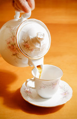 pouring tea to a teacup