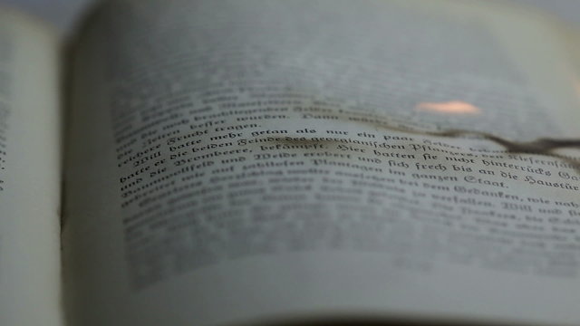Burning pages of an antique book