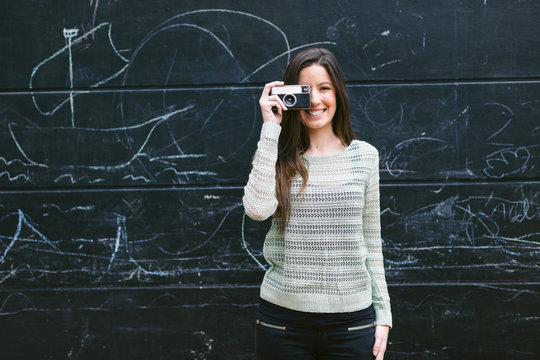 Young Woman Taking A Photo With An Old Camera.