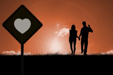 Fototapeta premium Composite image of happy couple walking holding hands