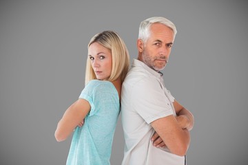 Composite image of unhappy couple not speaking to each other