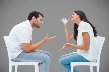 Composite image of couple sitting on chairs arguing