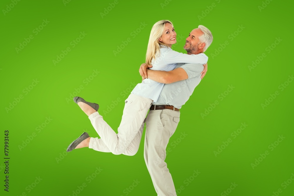 Aufkleber Composite image of man picking up his partner while hugging here