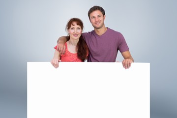 Composite image of couple looking at the camera