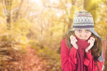 Composite image of cold redhead wearing coat and hat