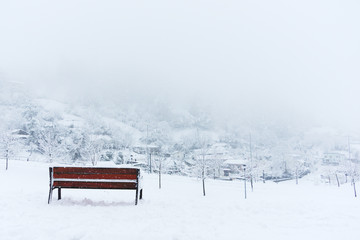 bench and snowy winter landscape