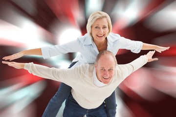 Composite image of happy mature couple having fun