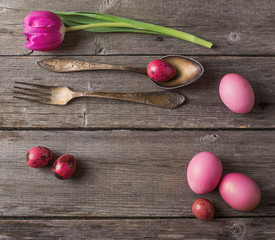 vintage silverware fork and spoon with easter eggs on old wooden