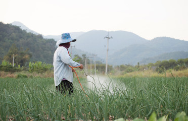 farmer spraying pesticide