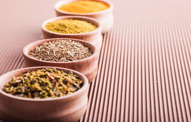 cumin,turmeric,hops-suneli,paprika in a wooden bowl