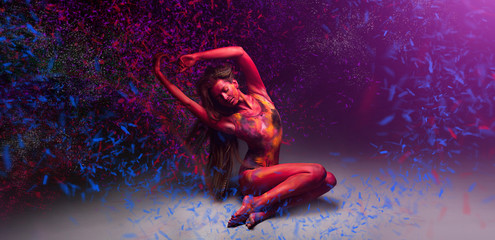 woman relaxing and dance with magic colored flor snow 