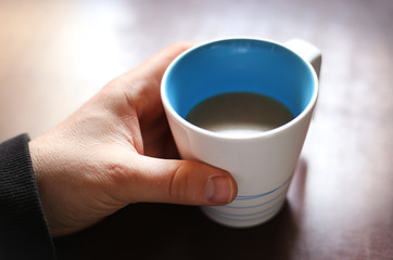 Hand holding coffee cup