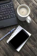 Obraz na płótnie Canvas Office desktop with coffee, notepad and laptop.