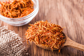spices saffron in a glass bowl and spoon close-up