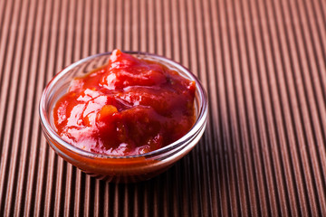 adjika in a glass bowl close-up